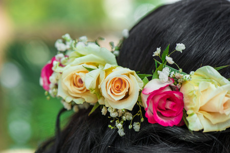 Female hair with beautiful colorful flower crown. Cheerful bride and bridesmaids party before weddingの写真素材