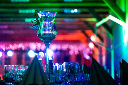 New years celebration, Luxuriously made tables. Music, romantic lights, champagne and wine. People are having fun. Holidays, vacation, party, fun, drinks, perfect mood to party hard all night longの写真素材