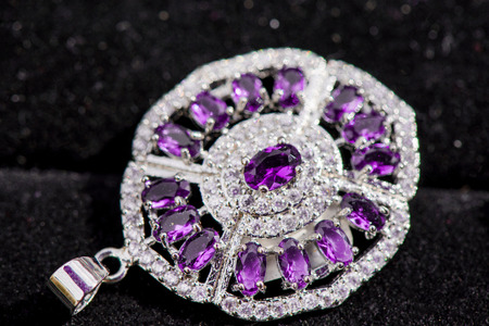 Macro shot of silver pendant with zircon stone and topaz on black background. Beautiful, handmade and expensive jewelry. Meditative, calming, healing and powerful crystalsの写真素材