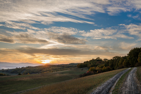 Romantic, bright and colorful sunset over a mountain range in Transilvania. Beautiful, colorful autumn backgroundの写真素材