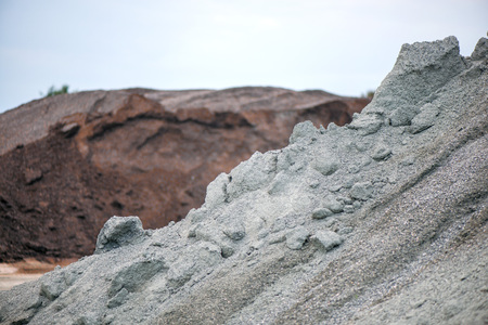 Large piles of construction sand and gravel used for asphalt production and building. Limestone quarry, mining rocks and stones -の写真素材