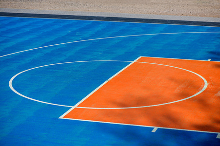 Abstract, blue background of newly made outdoor basketball court in park. Visible asphalt texture, freshly painted linesの写真素材