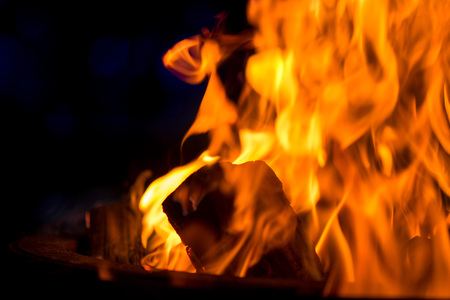 Ignite the fire. Warming up the cold winter nights. A macro shot of firewood, white dust and hot,...