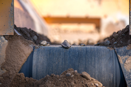Rock filtering conveyor belt at a quarry. Pebbles and gravel falling out of a filtering facility onto a conveyor beltの写真素材