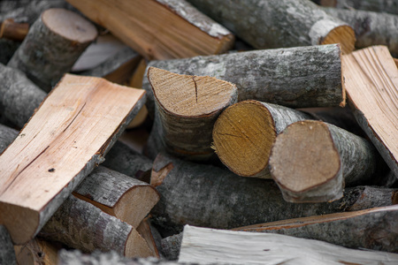 A pile of stacked firewood, prepared for heating the house. Gathering fire wood for winter or...