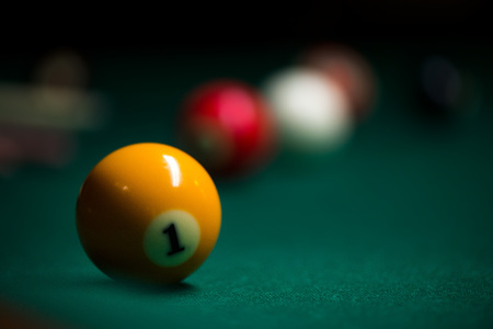 Sport billiard balls on green billiard table in pub. On going billiard game. Competitive players trying to find out the winner of the round.の写真素材