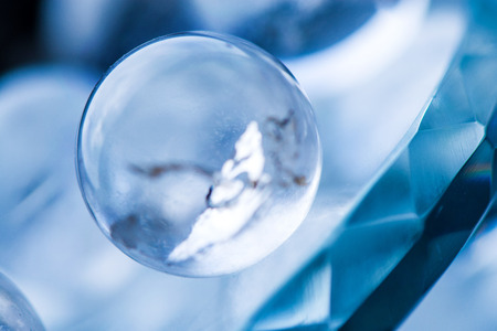 Fortune telling. Love, money, luck, success. Macro shot of transparent crystal ball with orange...
