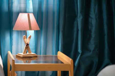 Bright eco light in the corner of a modern bedroom. New led technology meets traditional interior design.の写真素材