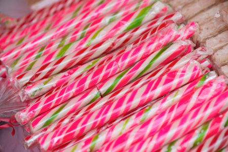 Natural honey sourced sweet candy in different shapes and colorful designs at a local state fair. Sweets and lollipops for kids. Concept of unhealthy eating, too much sugar. Diabetesの写真素材