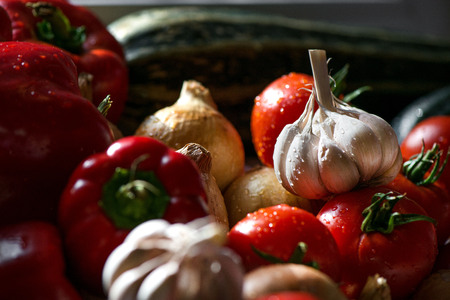 Ripe fresh harvested vegetables on table. Onions, tomatoes, garlic, pepper, zucchini in kitchen....