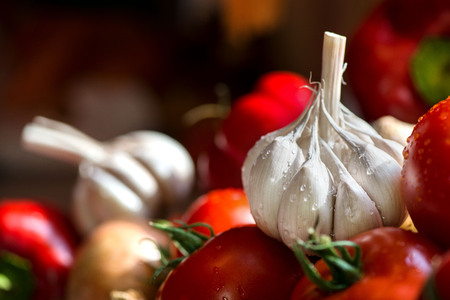 Ripe, fresh, harvested vegetables on table. Onions, tomatoes, garlic on kitchen table prepared to make a delicious vegetarian meal or for canning veggies for winter in jars. Concept of healthy eatingの写真素材