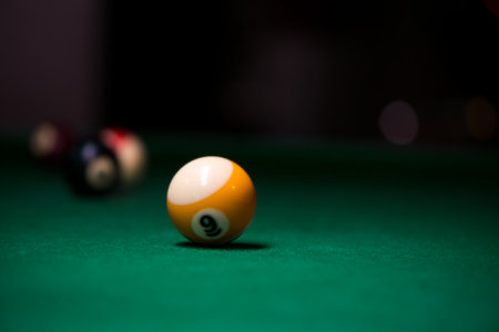 Sport billiard balls on green billiard table in pub. On going billiard game.の写真素材