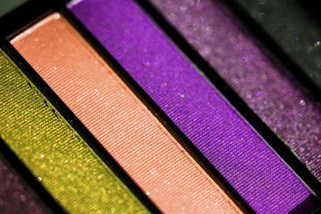 Top, up view of professional cosmetics, makeup background. Brushes and colorful palette of eye...