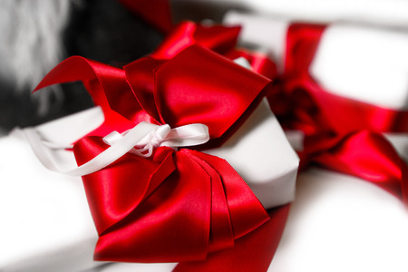 Lovely presents under Christmas tree, gift boxes on white, fluffy, cozy blanket background with...