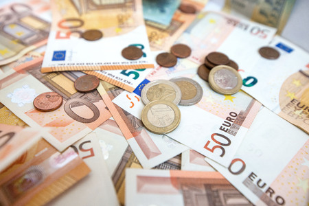 50 euro paper money and coins background. Hundreds of banknotes. Concept of cash flow, finances,...