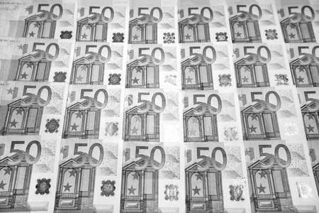 50 euro paper money on black background. Hundreds of banknotes. Concept of cash flow, finances, rich...