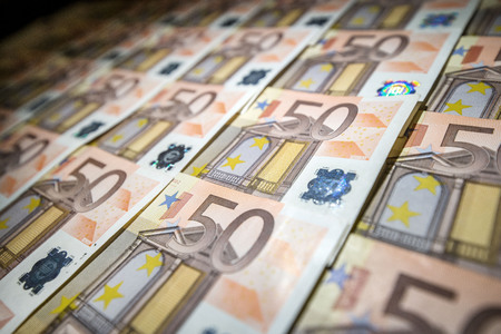 50 euro paper money on black background. Hundreds of banknotes. Concept of cash flow, finances, rich...