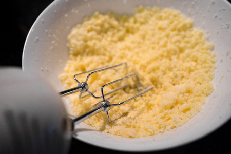 Mixer mixing whipped cream or egg cream with sugar in bowl. Concept of baking a cake for birthday or anniversary.の写真素材