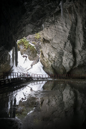 Underground glacier in Glaciers Cave in Apuseni mountains, Scarisoara, Romania. Big icicles holding on ceiling in the caveの写真素材
