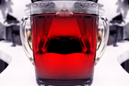 Abstract, blurry shot of cup of hot red fruit tea. Concept of science and medicineの写真素材