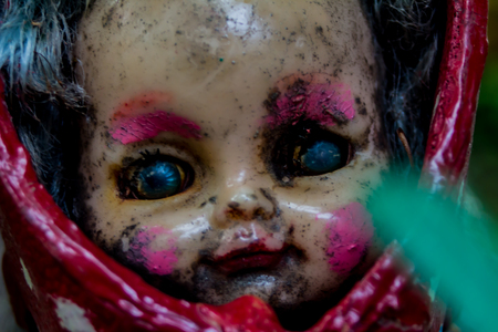 Scary cracked old doll faceの写真素材