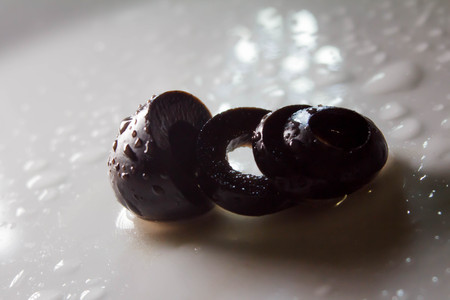 Bowl of pickled olives isolated on white background, top viewの写真素材