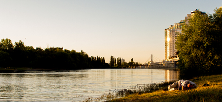 drunk man lies on the banks of the riverの写真素材