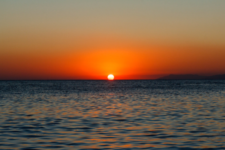 Bronze sea sunset and blue deep seaの写真素材