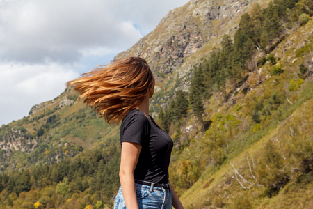 dissolved girl hair against the backdrop of the mountainsの写真素材