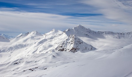 Snowy Mountains in blue and white skyの写真素材