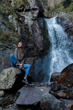 Nice Girl traveler at the mistyc waterfallの写真素材