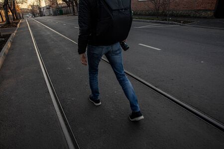 A photographer walking on old rail tracks in Krasnodarの写真素材