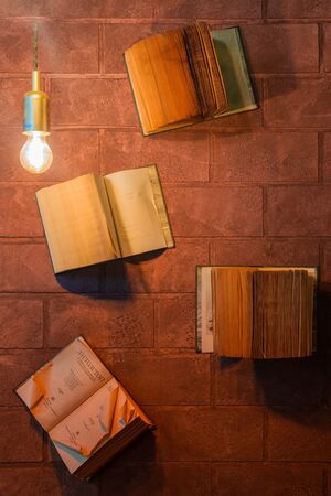 Stack of many old books on shelf in book store or library roomの写真素材