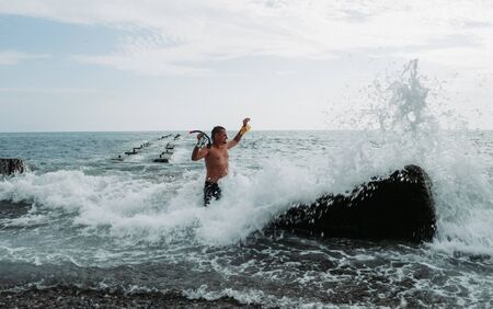 Seascape. Endless expanses of the sea and a man in the water, looking into the distance on a Sunny summer day.の写真素材