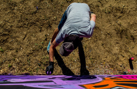 The artist draws graffiti on the wall.のeditorial素材
