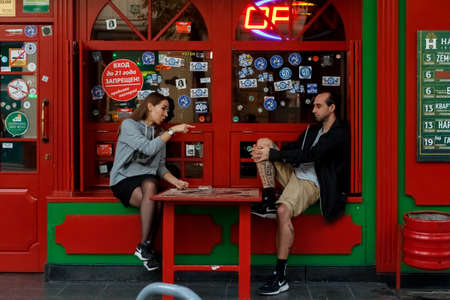 Conflicted couple not talking to each other seated on a wooden bench in park Portrait