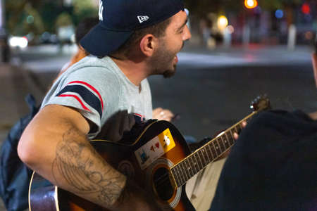 London, UK - August, 2019. Street musician playing a guitar during a performanceのeditorial素材