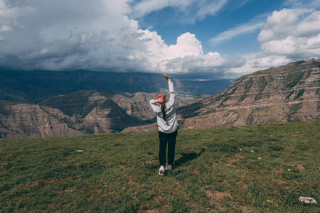 Pretty girl on peak mountain with perfect view.の写真素材