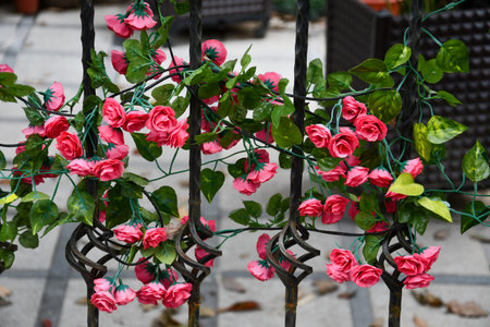 Plastic Flowers Wrapped On Iron Wire Backgroundの写真素材