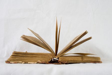 opened vintage book with white backgroundの写真素材