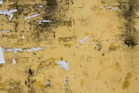 Poster Scraps Stuck to Old Grimy Painted Concrete Wallの写真素材