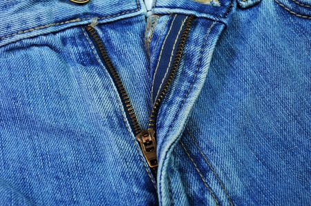 Zipper on a pair of faded jeansの写真素材