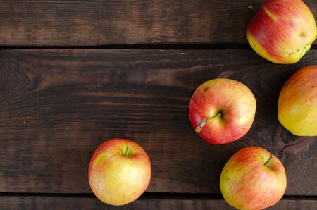 Organic apples on brown wooden backgroundの写真素材