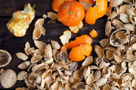 Organic waste. Top view. Nutshell, tangerine peelings, stump of an apple.