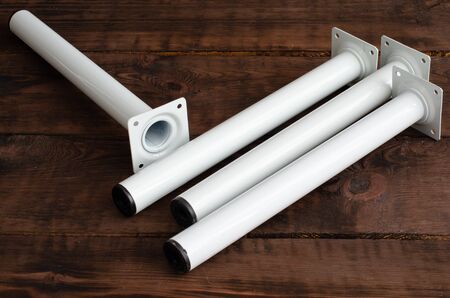 Four furniture legs on wooden background.の写真素材