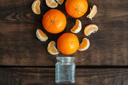 Mandarins and small phial on wooden backgroundの写真素材