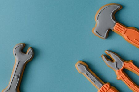 Ginger biscuit tools on blue background with copy space. Top view. Ginger cookies.の写真素材
