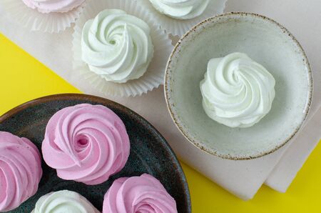 marshmallow on dish on yellow background. Marshmallow in cup. Marshmallow on linen. Top viewの写真素材
