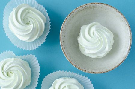 Marshmallow in cup on blue background. Top view. Zephyrの写真素材