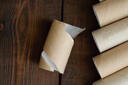 toilet paper cores on wooden background. Zero waste. Recycling. Top view.の写真素材